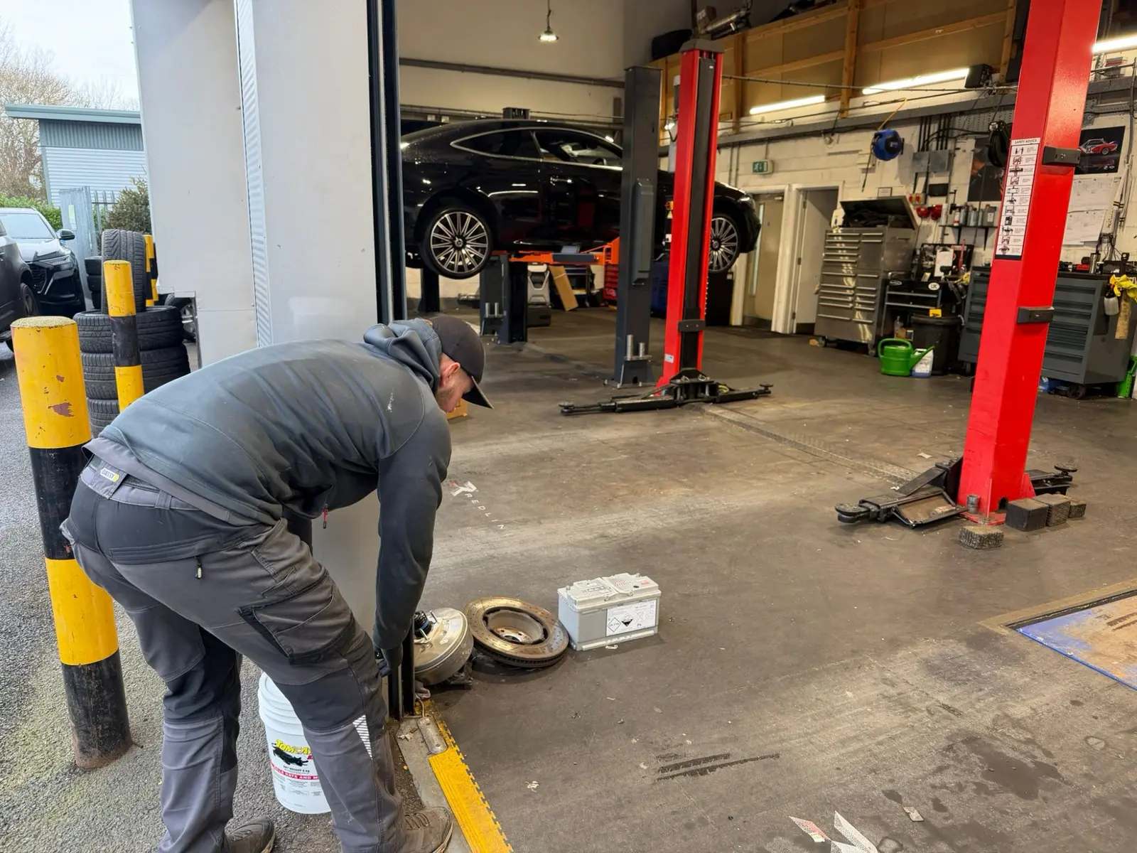 Pest Control Harrogate | Protecting £Million Prestige Stock 2 Commercial pest control technician installing tamper-proof rodent bait station at Red Line Cars Harrogate service area