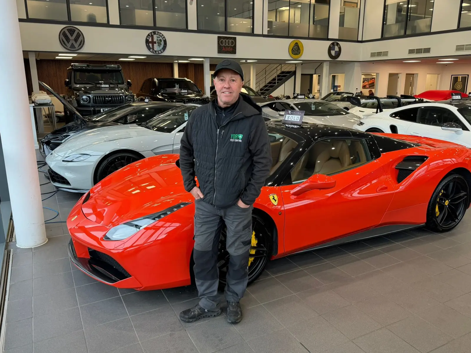 Yor-Pest Control technician in Red Line Cars Harrogate Ferrari Porsche showroom providing commercial pest control for prestige vehicles