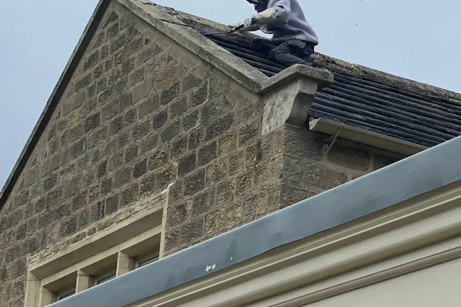 Wasp Season Harrogate: When to Act & What to Expect 2026 4 Professional pest control technician in full protective suit treating wasp nest on roof Harrogate demonstrating safety equipment required